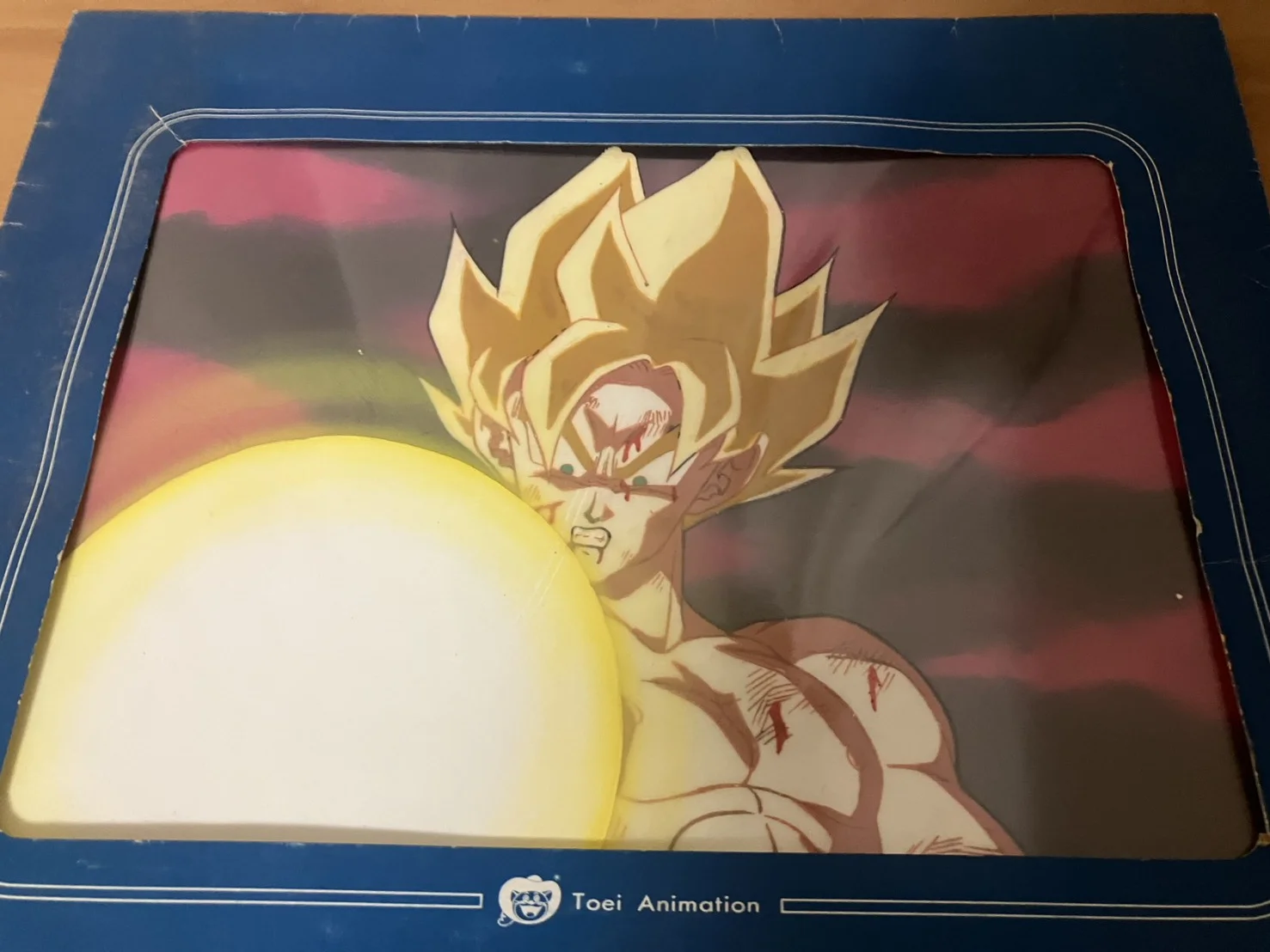 Toei Animationのロゴ入りの青い台紙に入ったドラゴンボールZのセル画(超サイヤ人の孫悟空)